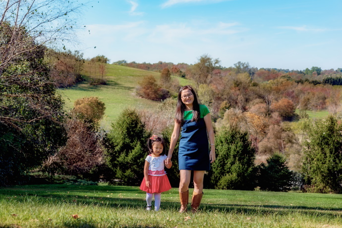 Li Teng outside with her daughter surrounded by trees
