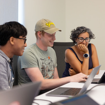 three people at a computer