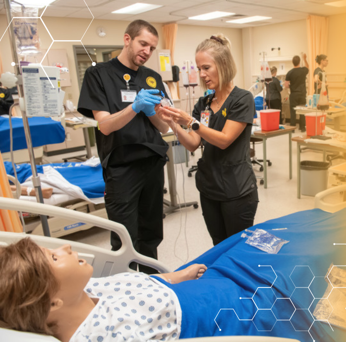 Nursing students working on a training mannequin.