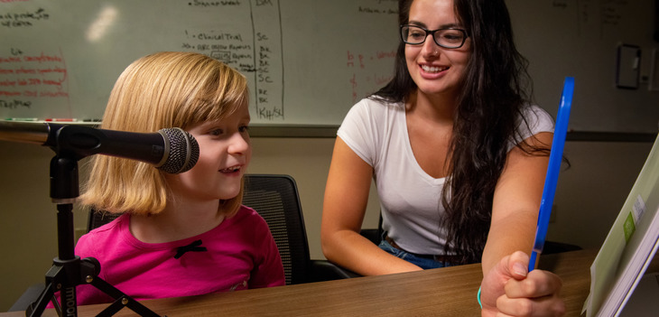 Student working with a child 