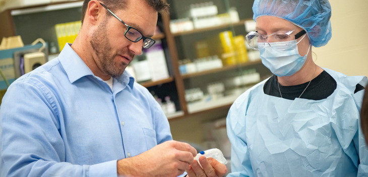 Student working with instructor in a lab.