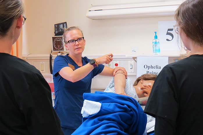 Nursing students treating a artificial patient. 