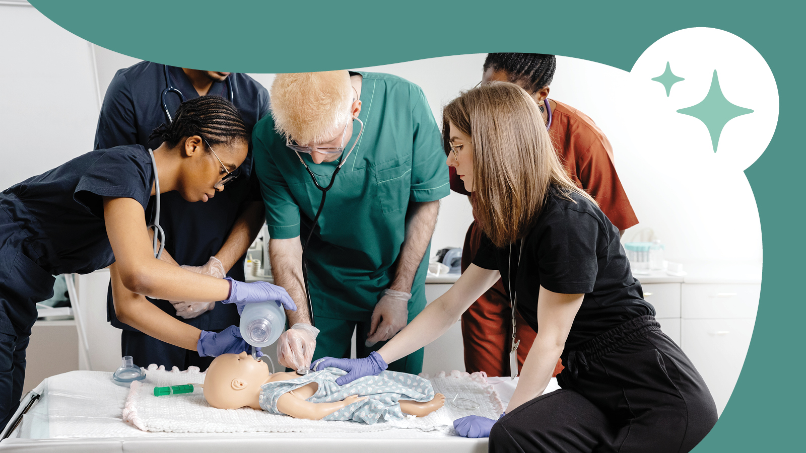 A group of residents in training learning on a baby mannequin.