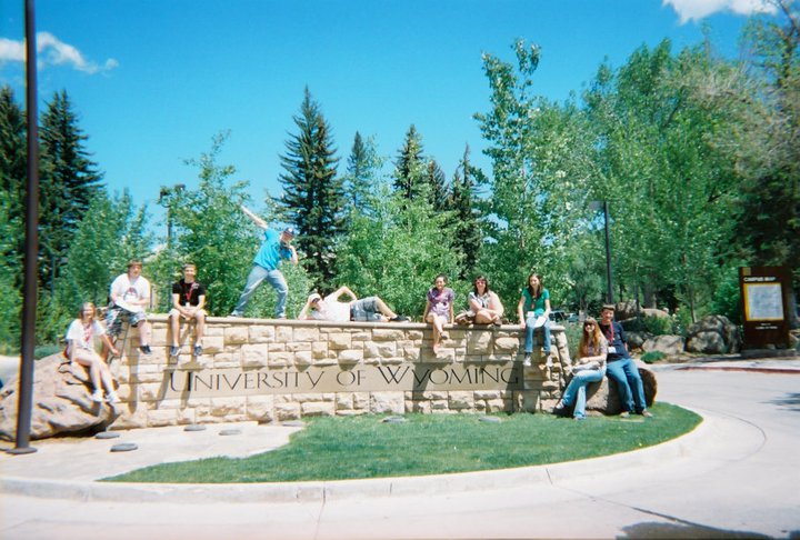 students around UW's sign