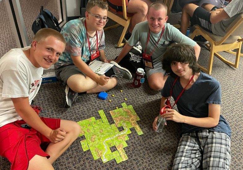 Chauncy and a group of students playing Katan on the fishbowl floor.