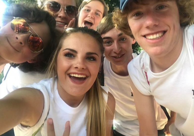 Selfie with 6 HSI students wearing white shirts and having a great time together.