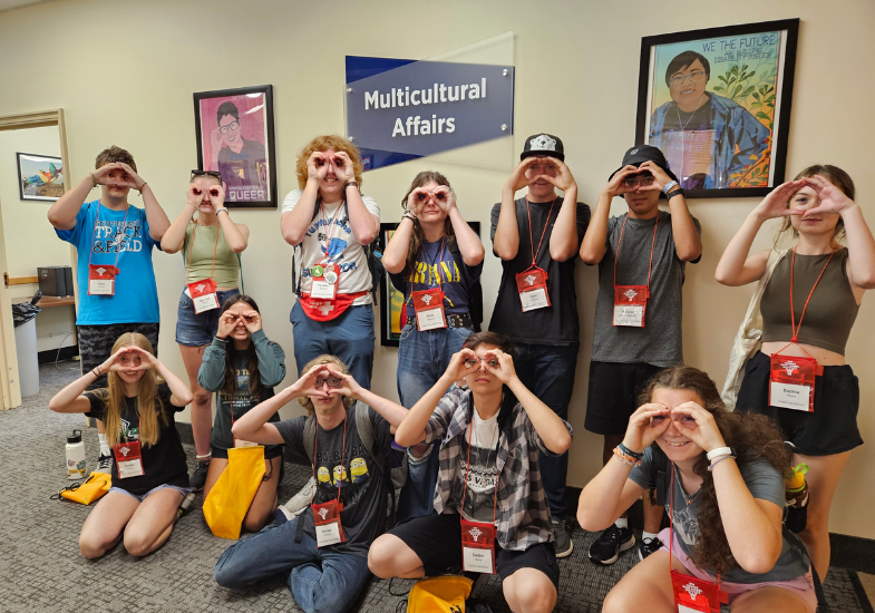 HSI students with their PC Grant in front of Multicultural Affairs stricking a Minion pose.