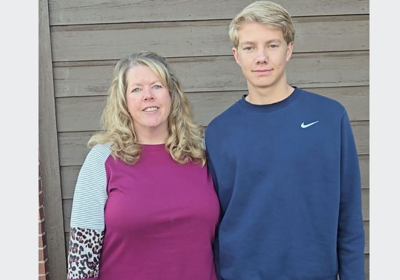 Laura and Landon Olson standing together and smiling.