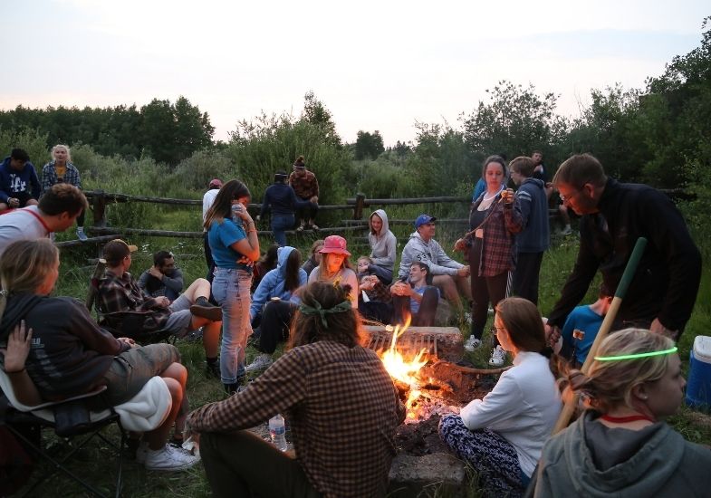 HSI students around a campfire.