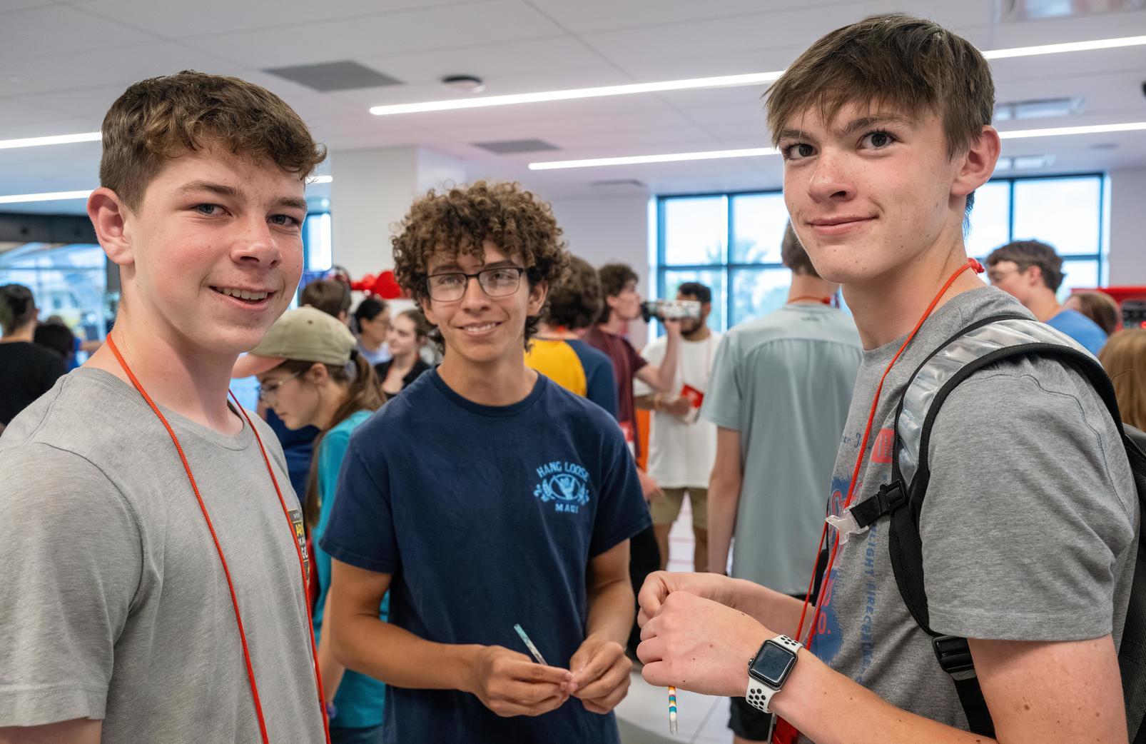 Three boys in the energy lab on campus.