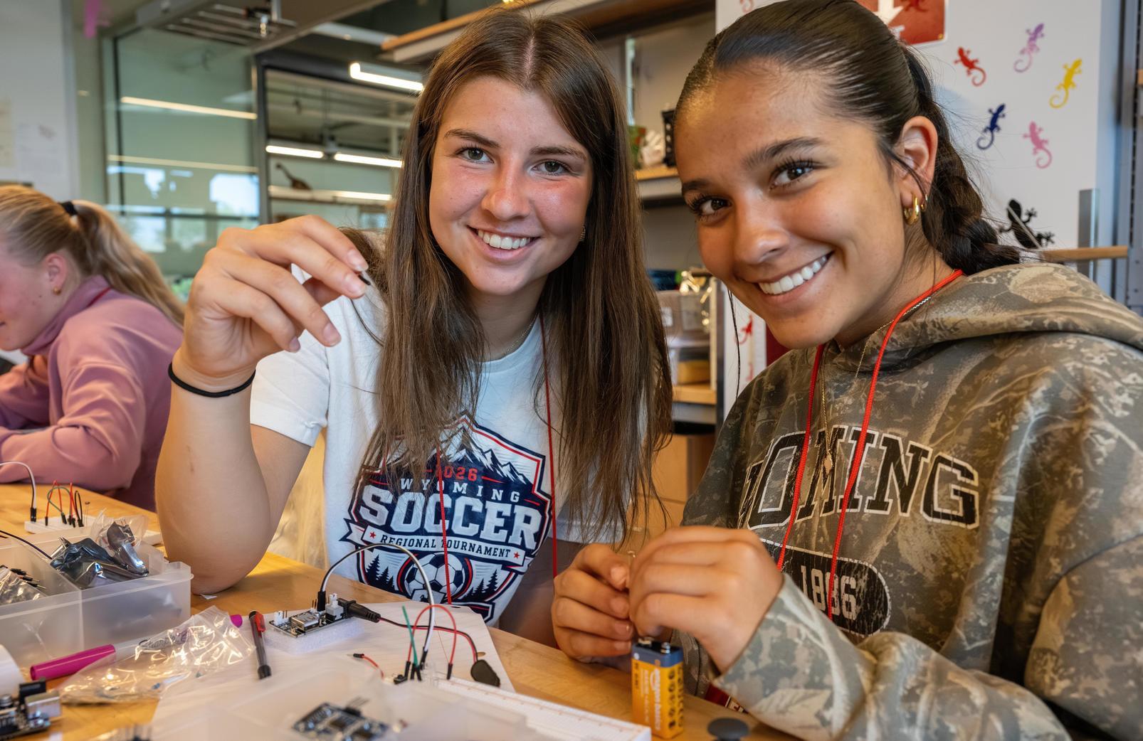 Two female students working on their robot in their science class.