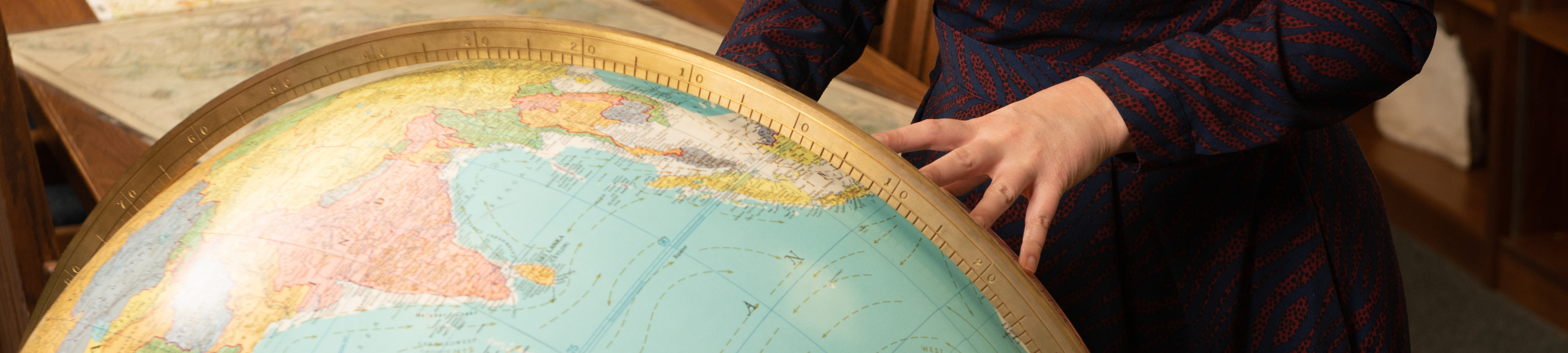 Hand on globe