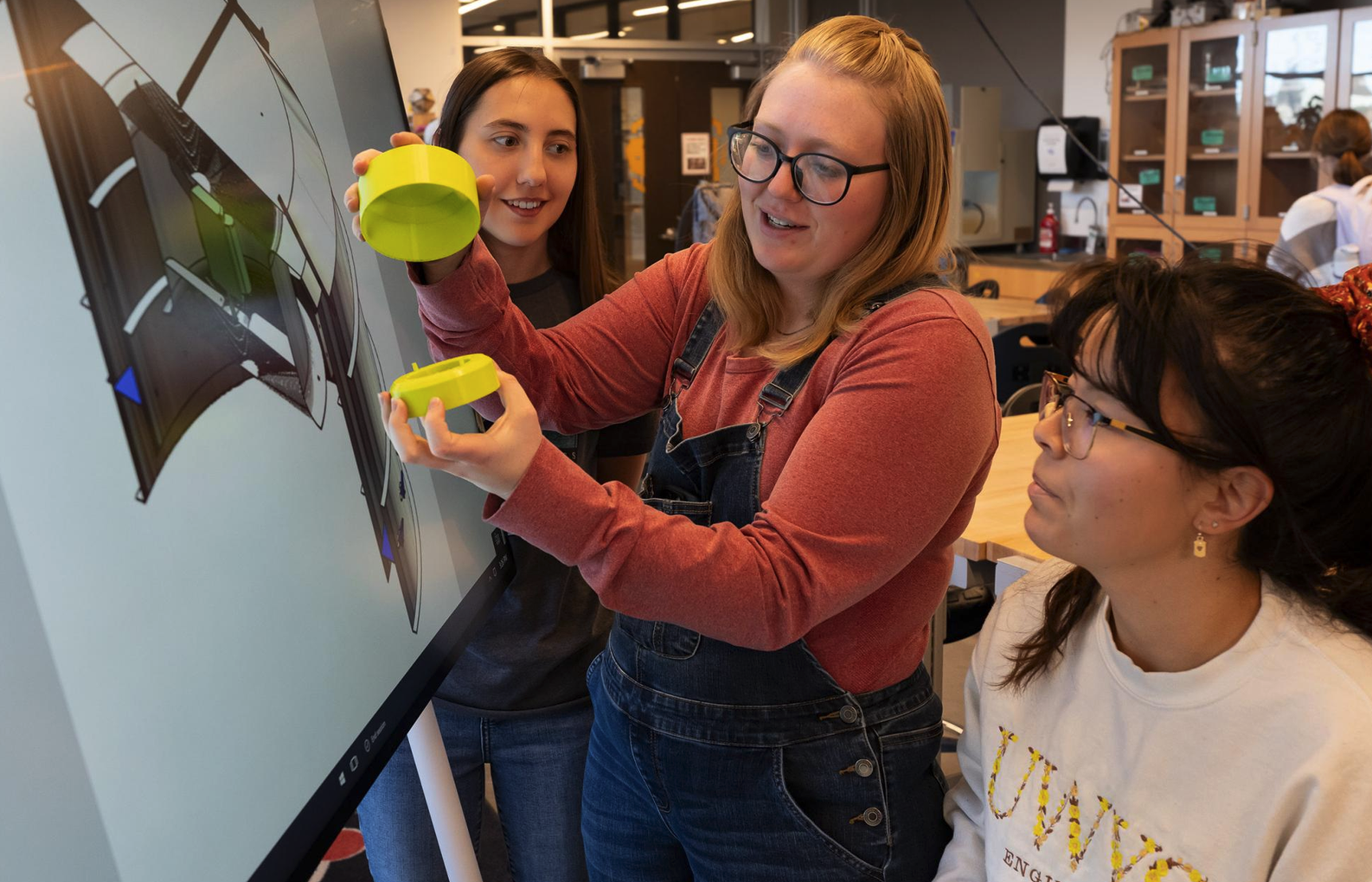 photo of 3 students discussing 3D printing design