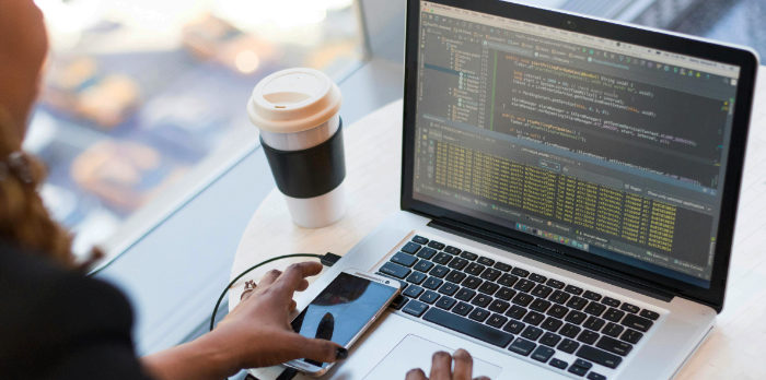 student working with coffee on a laptop computer