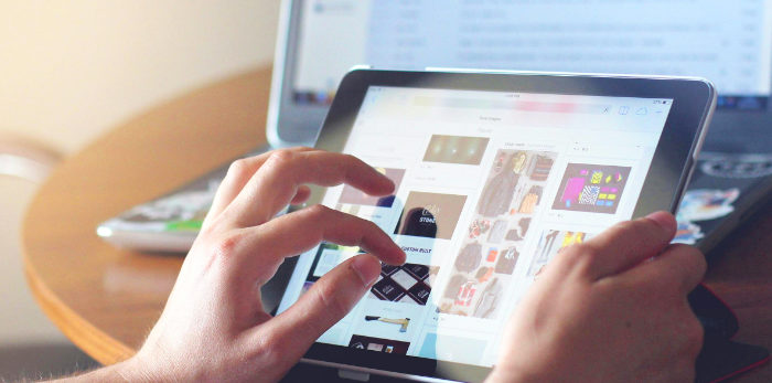 student using a tablet computer two-finger expand
