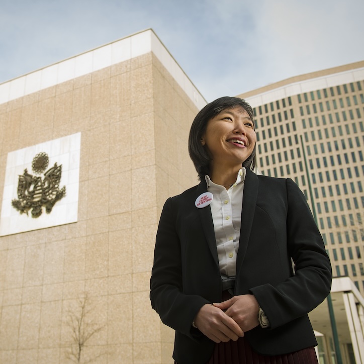employee standing in front of a building