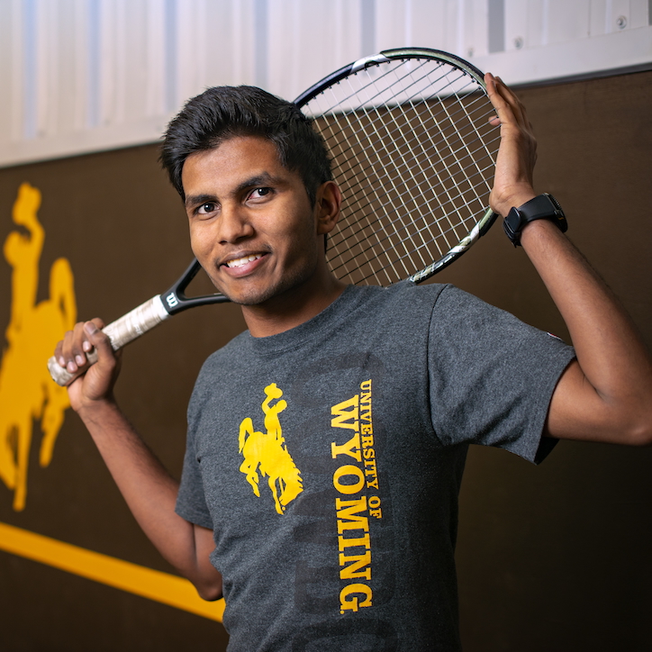 tennis player with racket behind head