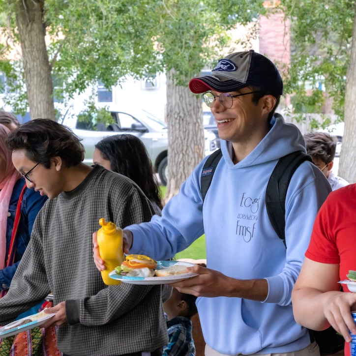Student with a plate of food outside