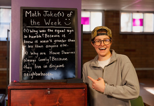 UW staff poses with math question of the week