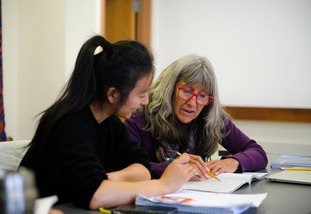 A UW international student and UW staff member work together at the English Language Center.