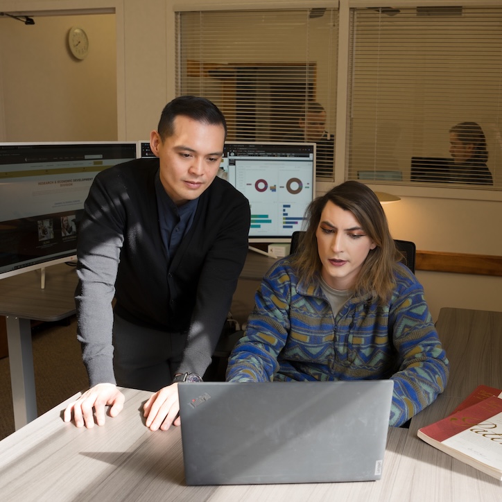 Two workers in front of laptop