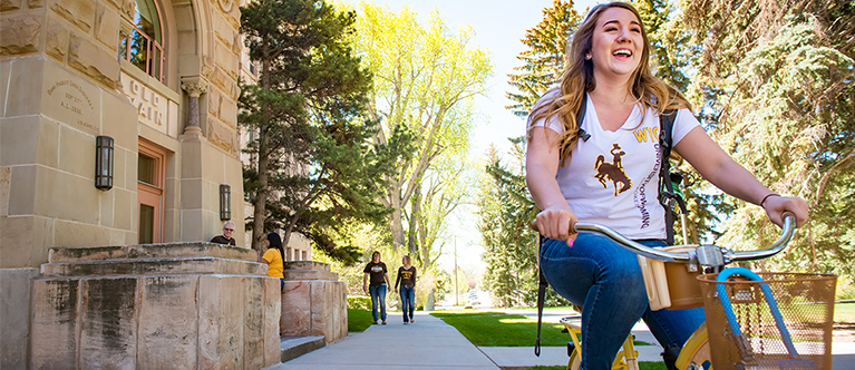 College student riding a bike.