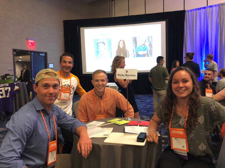 A group of people at a conference smiling at the camera.