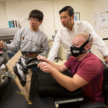 Three people in a research laboratory.