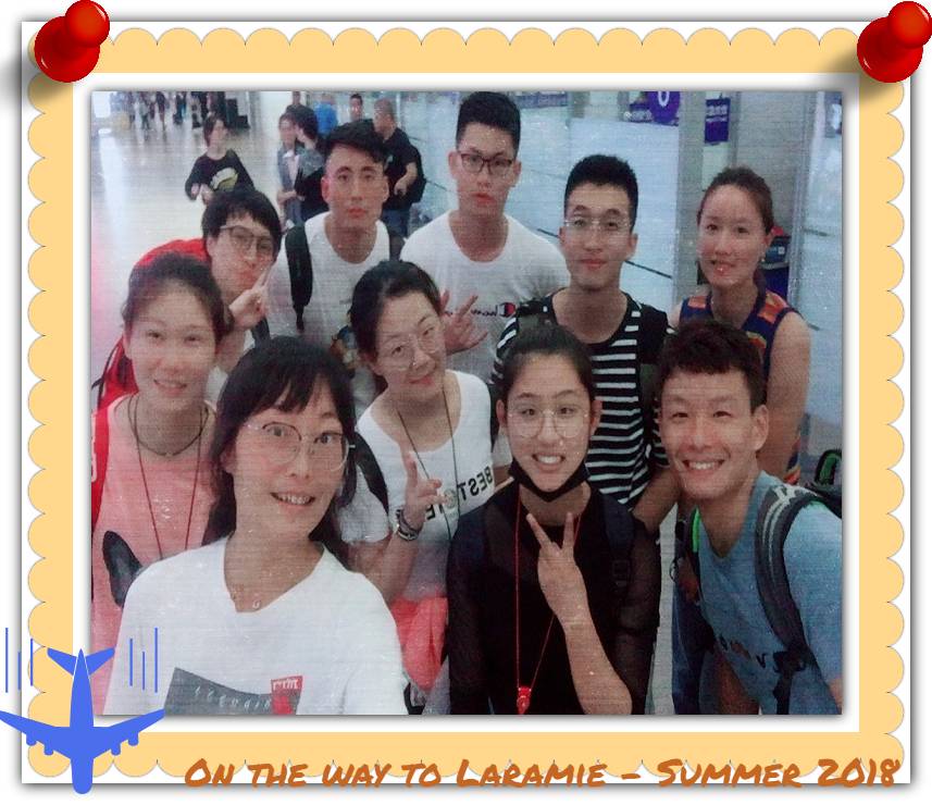 A small group of students stand together and smile at the camera.