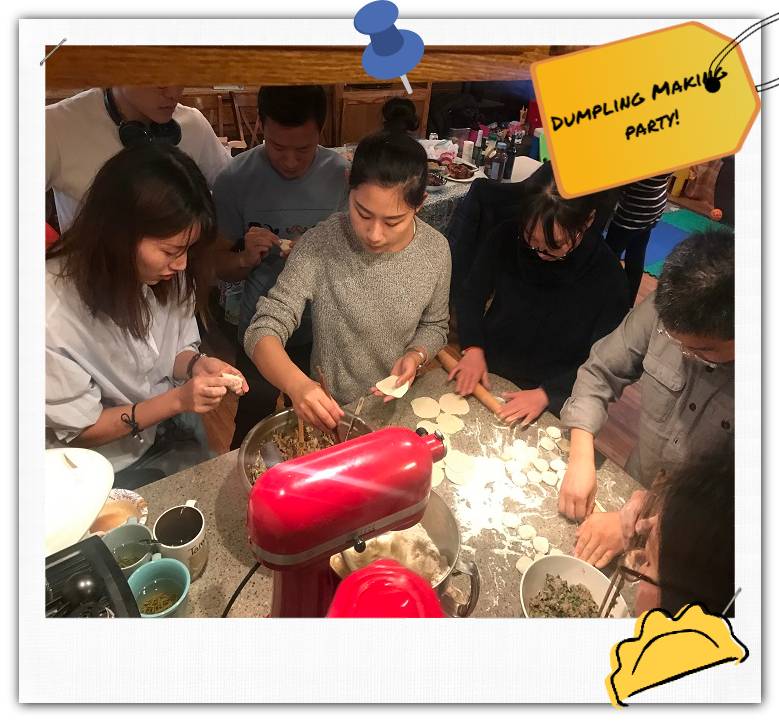People at a kitchen counter making dumplings.