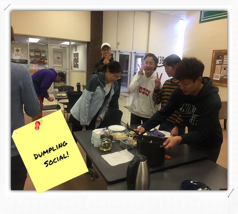 People set up food on a table.