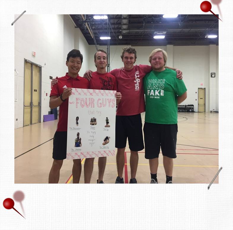 Four men showing off a handmade poster for their team group called, "Four Guys Try".