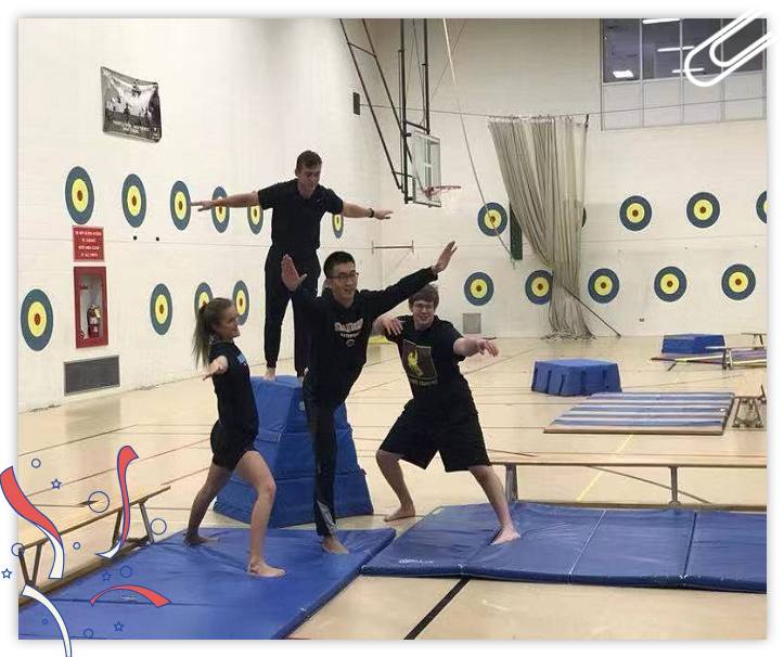 Four people doing tumbling gymnastic exercises.