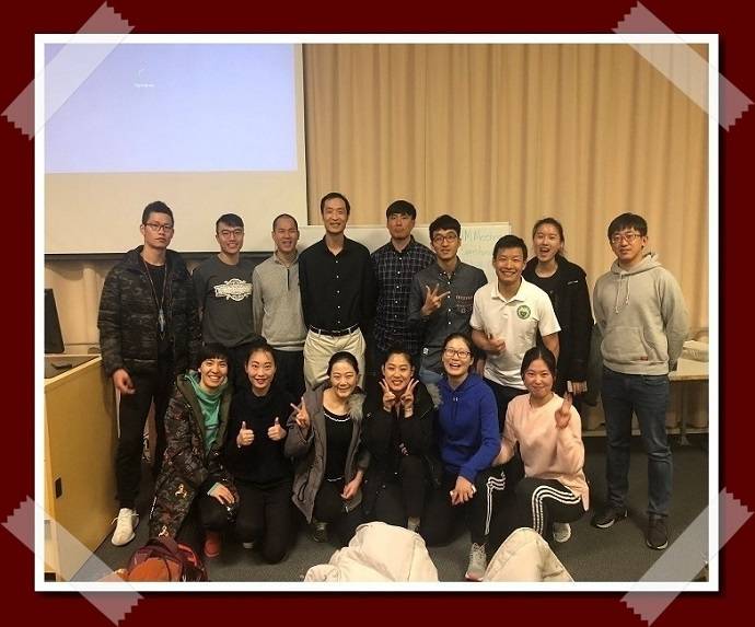 A group of people standing together and smiling at the camera.