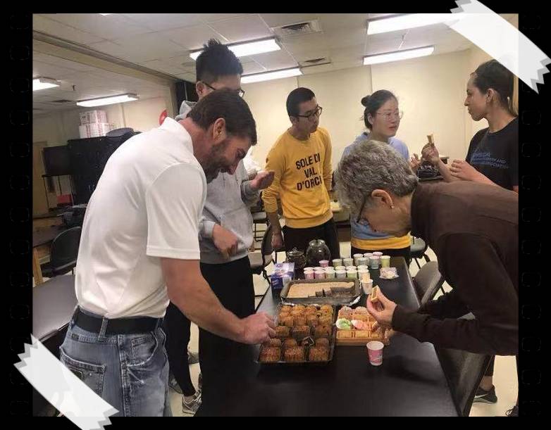 People look down at a table with snacks on it.