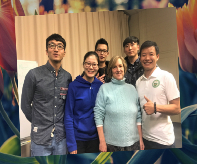 A small group of peole standing together and smiling at the camera.