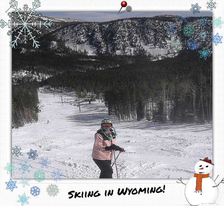 A person in skiing gear at the top of a snowy slope.