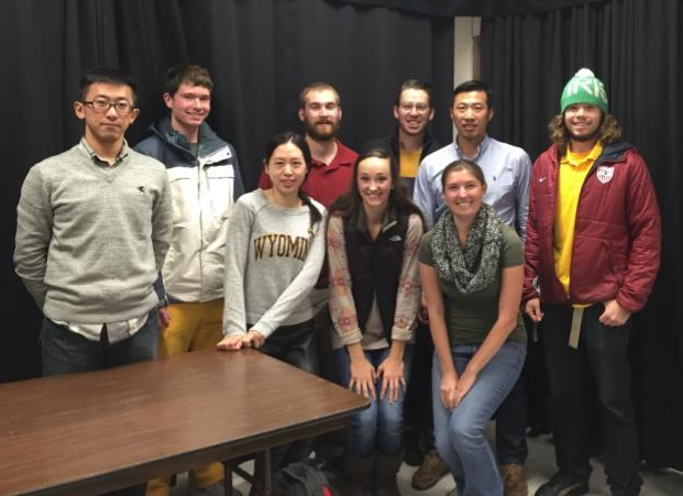 A group of people standing together and smiling at the camera.
