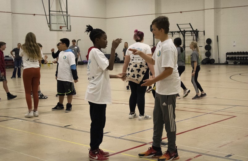 Kids playing in a school gym.