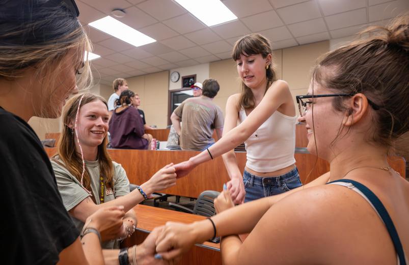 Student holding hands in a circle.