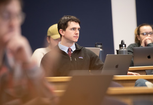 A student sits in class paying attention.