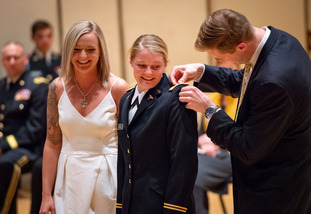 A student receives her military commission pinning ceremony.