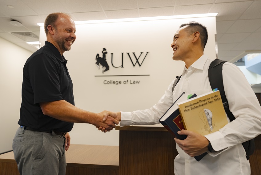 registrar greeting student at reception area