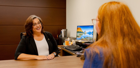 staff member and sitting at desk joyful 
