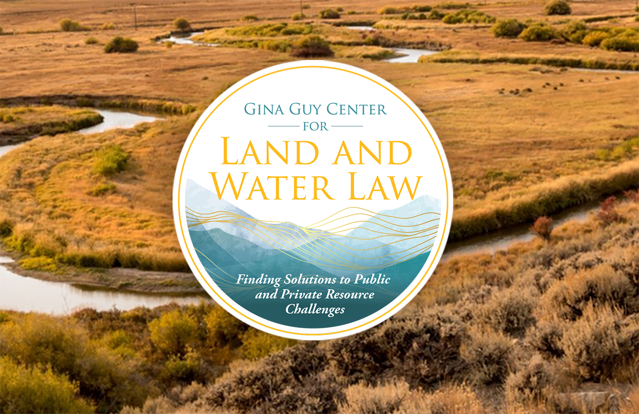 A photo of a river with the Gina Guy Center for Land and Water logo on top