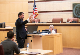 A law student speaks to a courtroom during a UW experiential learning course.