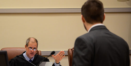student talking with judge in courtroom
