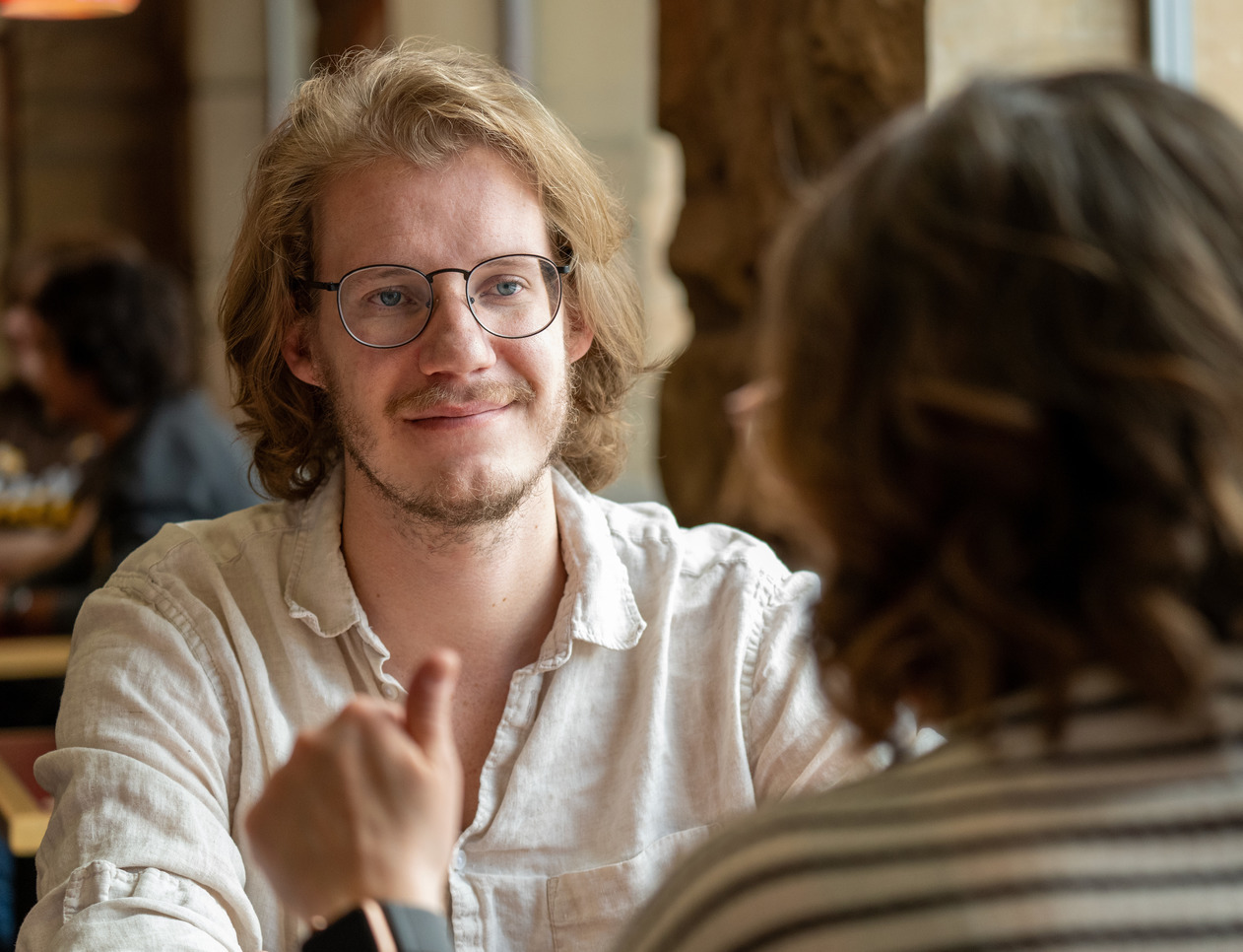 Two people are in conversation at the Rendezvous Cafe in Ross Hall.