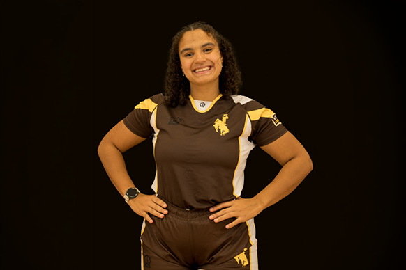 Ileah Mwangi poses in her University of Wyoming soccer uniform