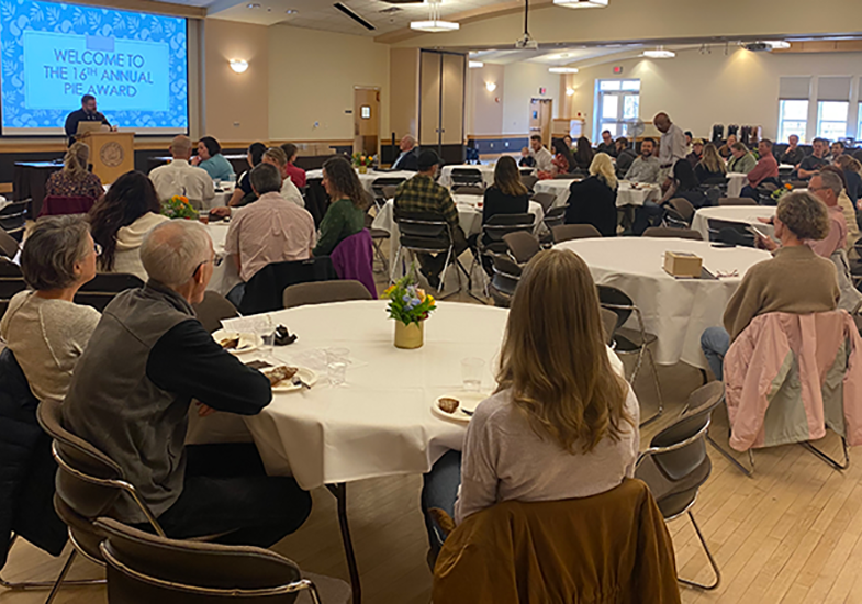 PIE Award Ceremony with round tables and speaker at podium